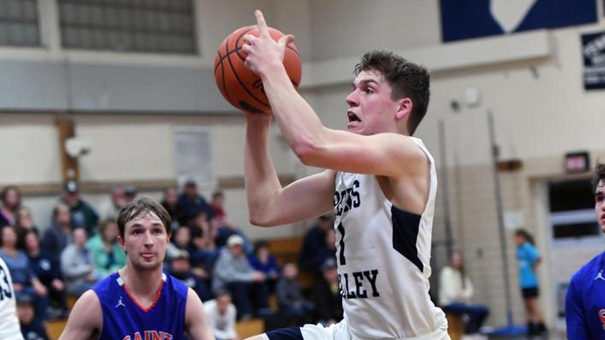 Penns Valley's Logan Snyder jumps up toward the net.