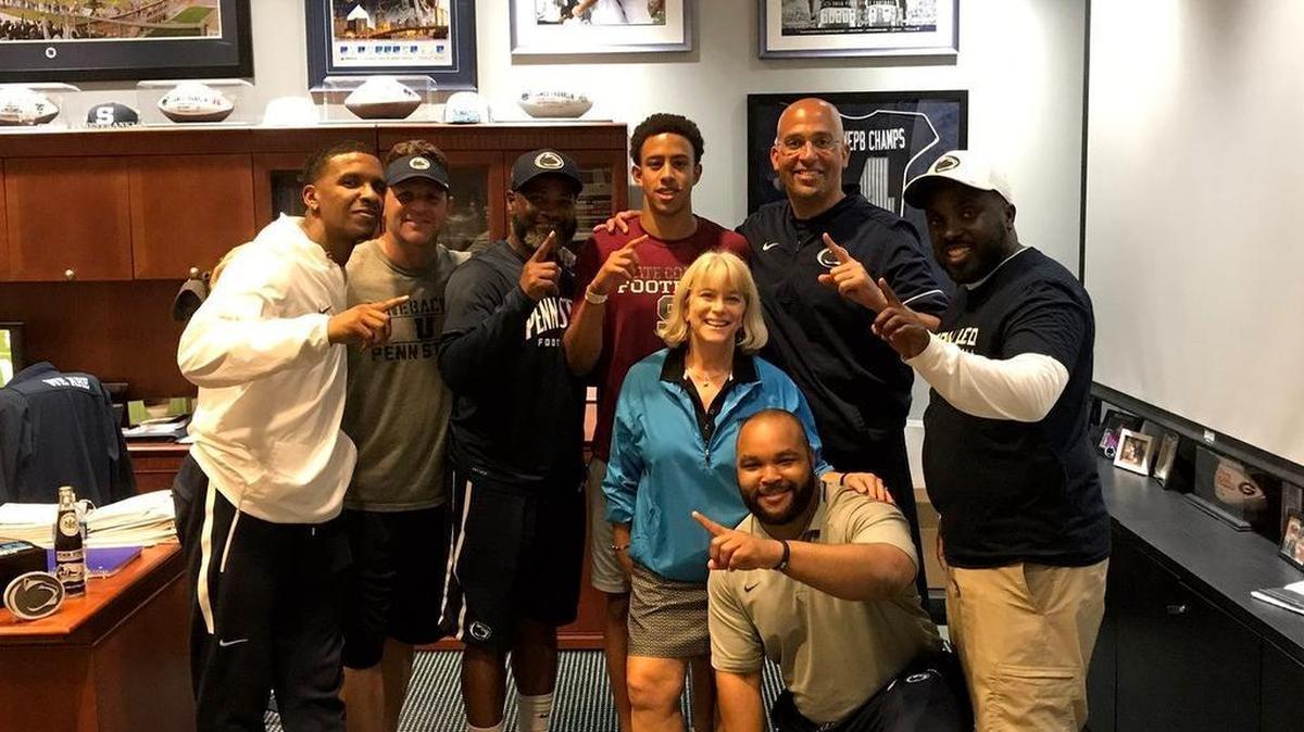 State College defensive back Keaton Ellis, center, poses with family and members of the Penn State coaching staff after receiving a scholarship offer to play football there. Ellis, a rising high school junior, is the first Little Lion to receive a football offer from Penn State in at least seven years.