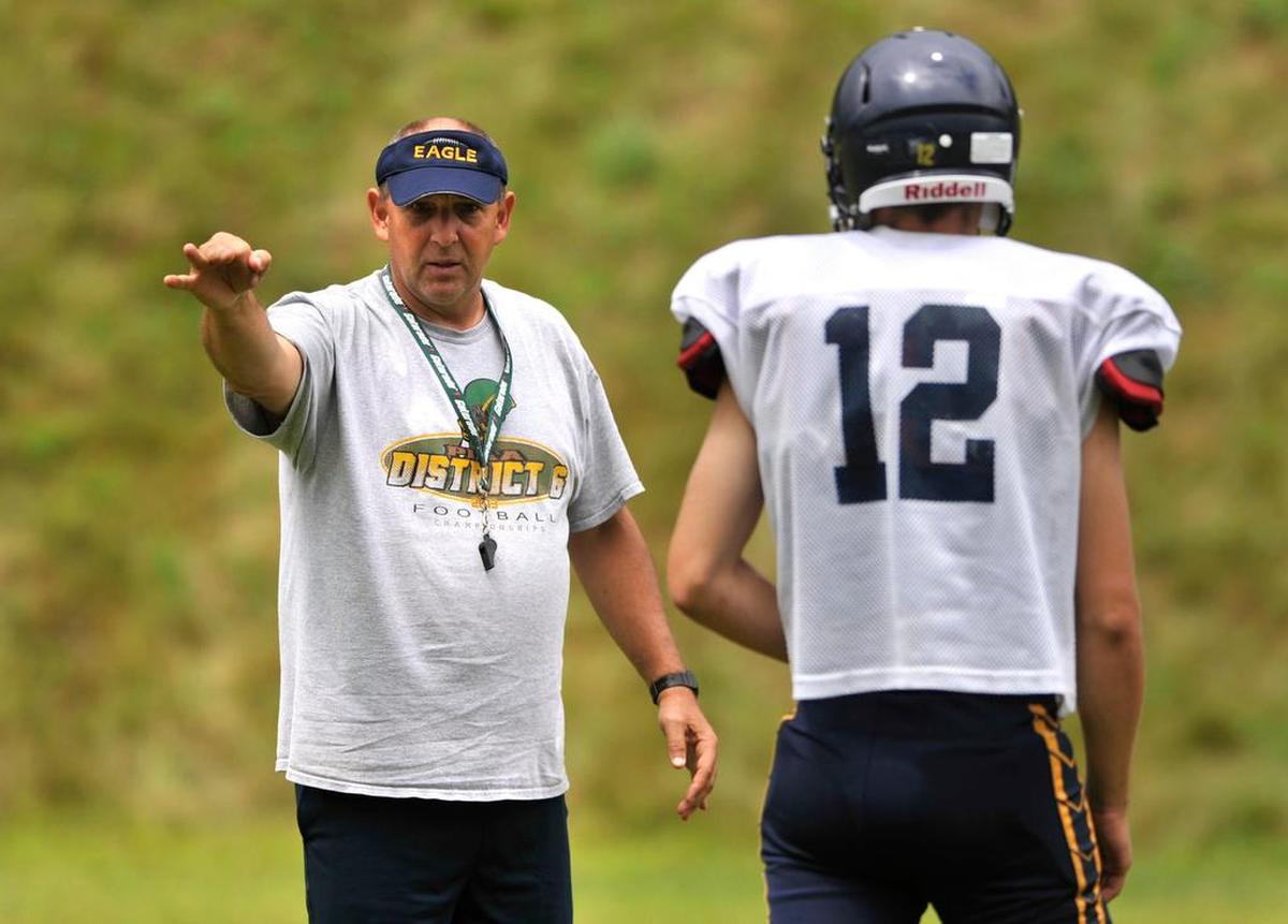 Ron Hoover talks to his quarterback during practice for the Bald Eagle Area High School football team on Aug. 12, 2014.