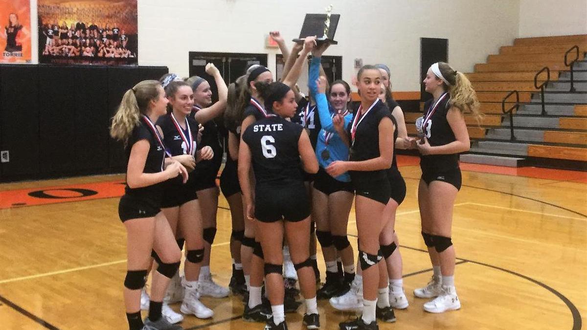 The State College girls’ volleyball team celebrates a four-set win over Altoona on Wednesday for the program’s seventh straight District 6 championship.