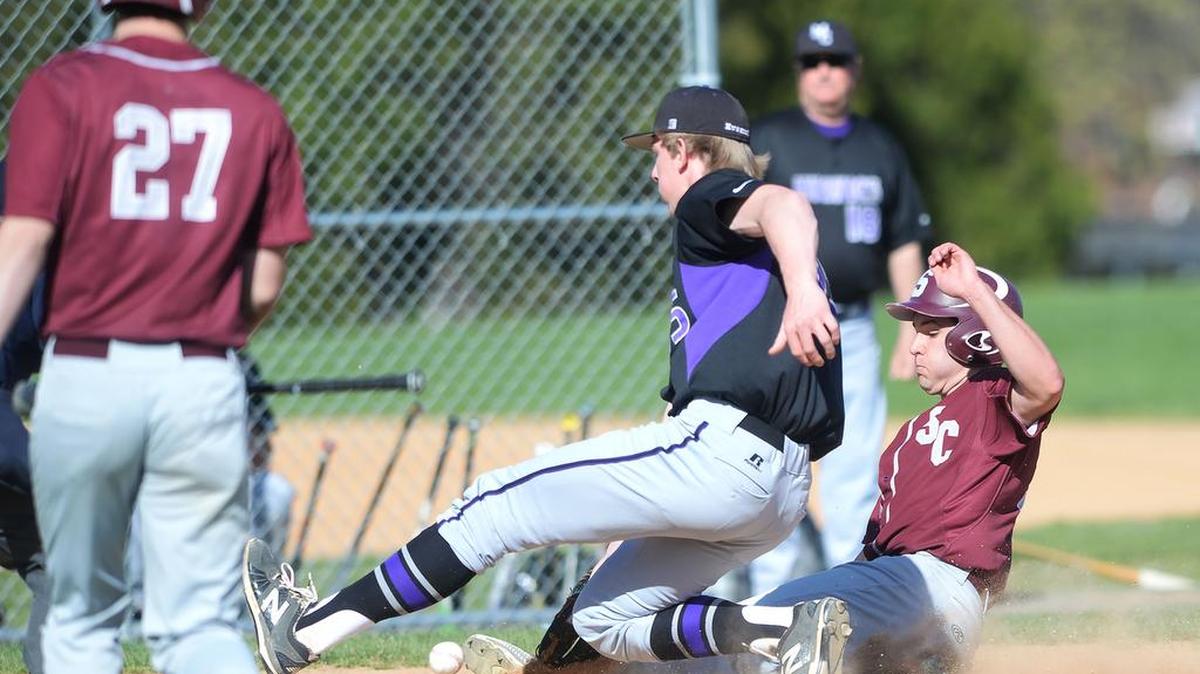 Mifflin County catcher Isaac Maclay (left) can’t hold on to the ball as State College’s Brandon Raquet (right) scores during Tuesday’s game in State College. Mifflin County defeated State College, 4-1.