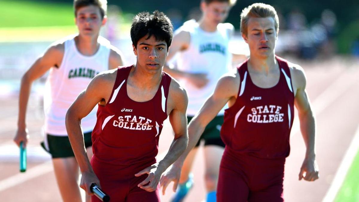 Craig Hilliard, right, hands the baton to Anthony Degleris in route to a win in the boys 4x800 meter relay. The State College Area High School girls' and boys' track and field teams faced Carlisle on April 19, 2016.