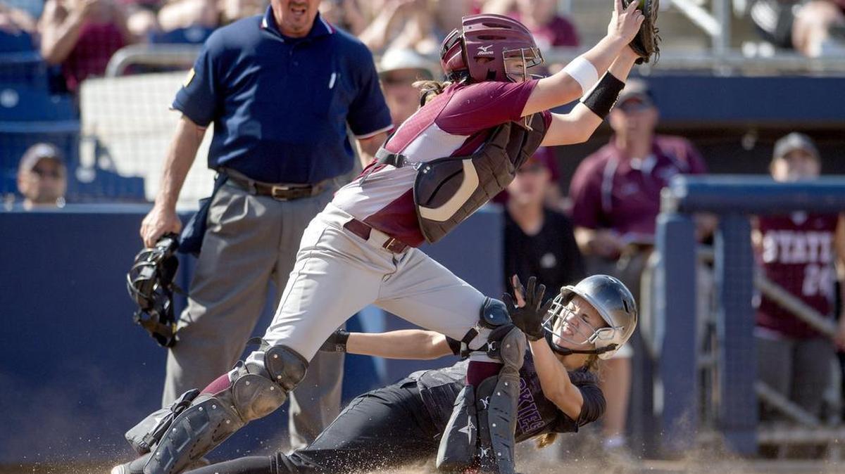 State College’s Avery Cymbor makes the catch to tag Mifflin County’s Ralie Goss out at the plate during the District 6 AAAA Softball championship game at Beard Field on Wednesday. Mifflin County won 9-1.