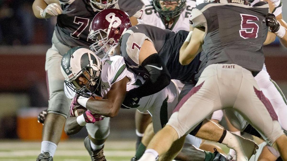 State College’s Alex Aspray tackles Central Dauphin’s ball carrier Michael Burgwin during Oct. 9, 2015 game at Memorial Field. Central Dauphin won, 35-17.