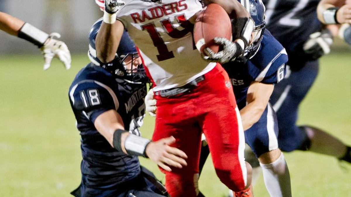 Bellefonte's Dexter Gallishaw runs past Philipsburg-Osceola defenders during the Friday, September 18, 2015 game. The Red Raiders won, 44-3.