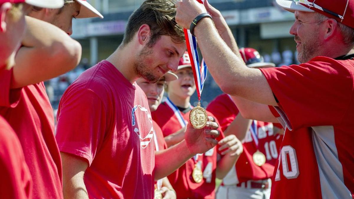 Bellefonte baseball coach Dan Fravel places a gold medal on pitcher Dom Masullo as the team celebrates its 2-0 win over Susquehanna Township in the PIAA Class AAA Championship on Friday, June 17, 2016 at Medlar Field.