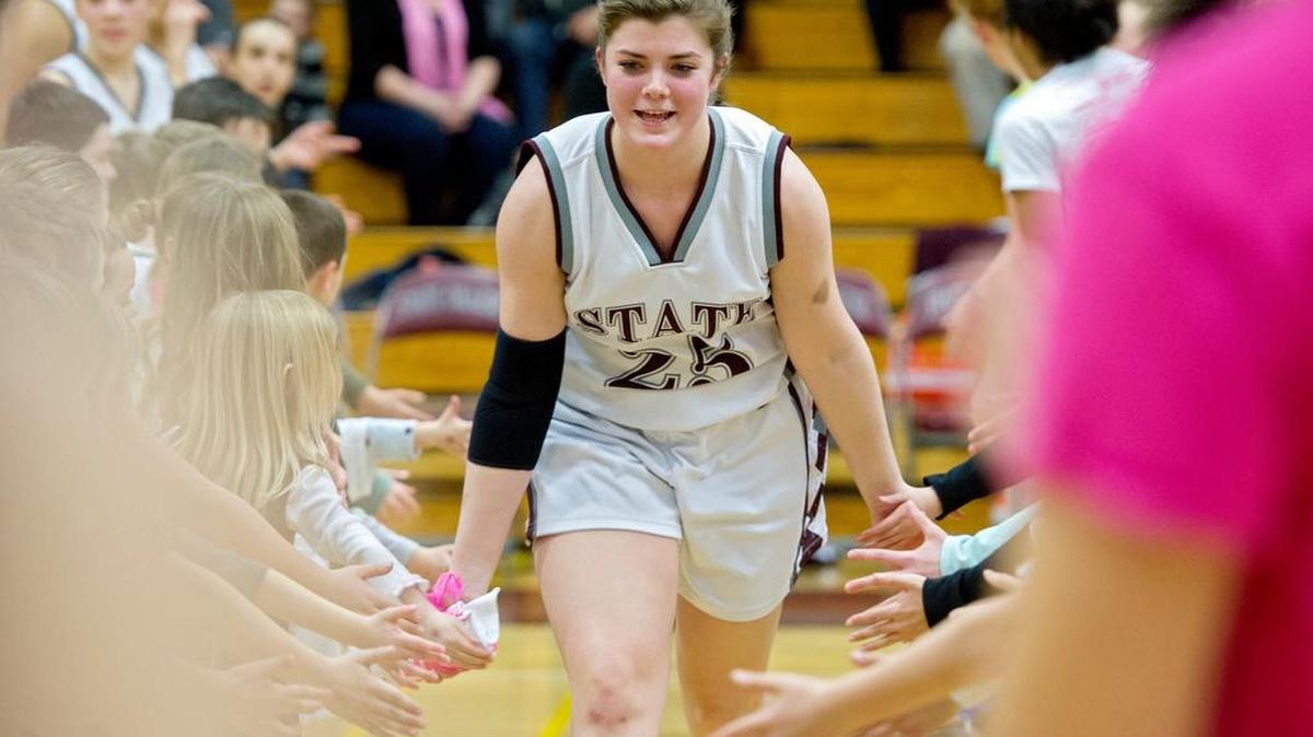 State College senior Kyla Irwin high fives her teammates and youngsters as she is announced for the game against Harrisburg on Friday, January 29, 2016.