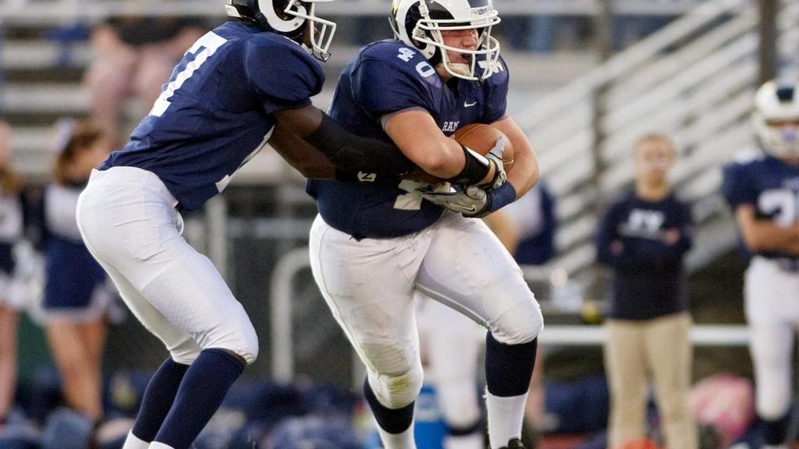 Penns Valley’s Chase Collison receives a hand off from quarterback Ben Alexander in 2014. Both Collison and Alexander have plans to play collegiate football this fall.