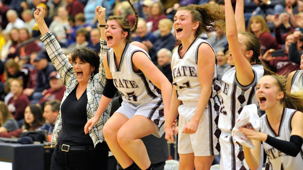 Coach Bethany Irwin and her team clebrate the victory over Altoona. The State College girls' basketball team beat Altoona 52-27 for the PIAA AAAA District 6 title Feb. 27, 2016.