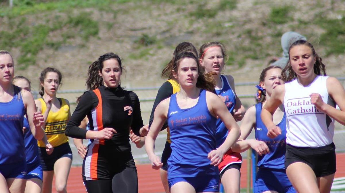 Saint Joseph’s Catholic Academy’s Lucia Person, center, along with teammate Sera Mazza (not pictured) will look to become the first Lady Wolves to compete at PIAA Track and Field Championships. The pair look for District 6 crowns on Tuesday at Mansion Park in Altoona.