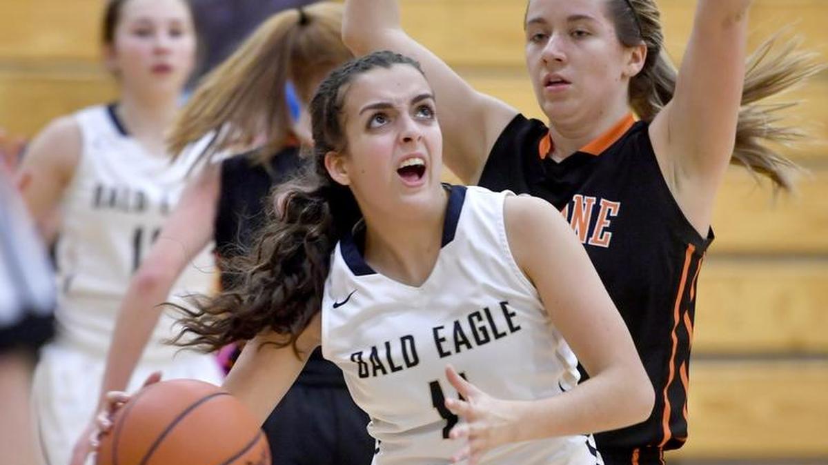Bald Eagle Area’s Julia Cingle, foreground, looks to the basket around a Tyrone defender during Friday’s game. Lady Golden Eagles soared past the Lady Bald Eagles 49-29.