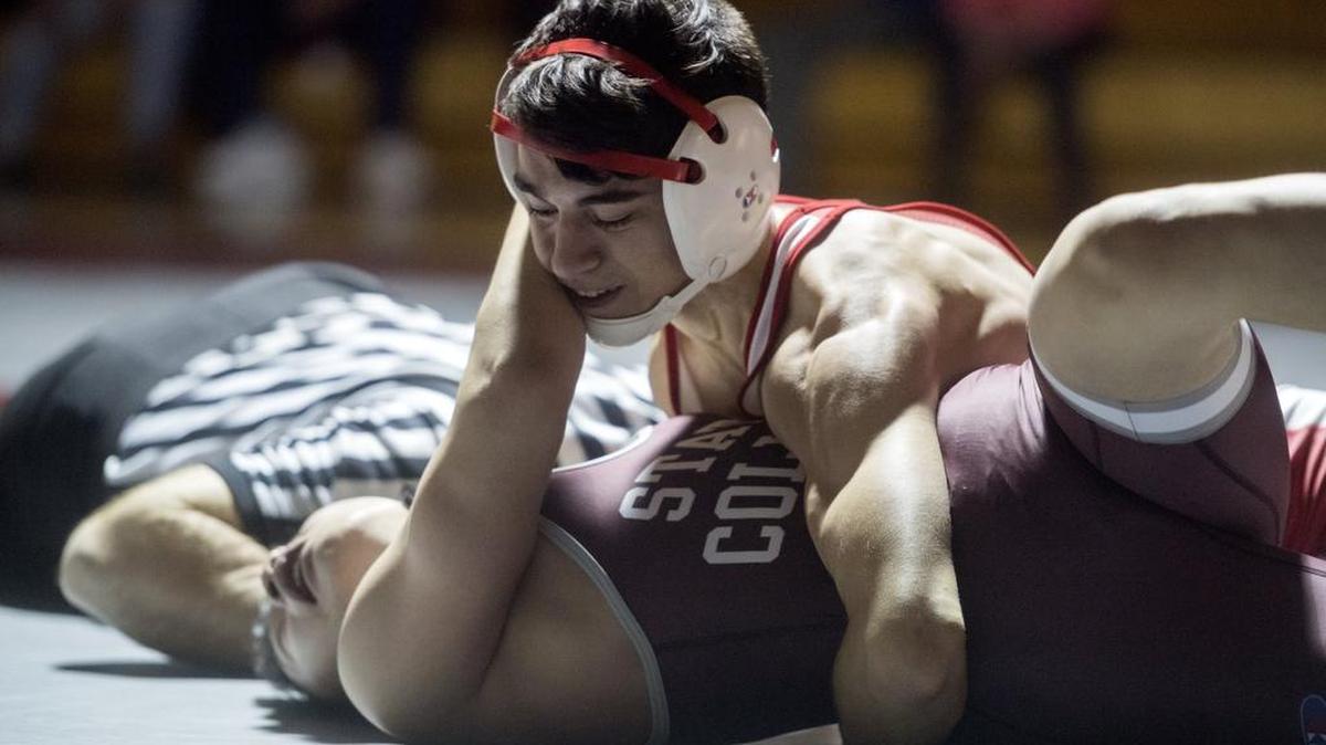 State College’s Isaac Sublett tries to push off Bellefonte’s Nate Wert in the 126-pound bout during the Tuesday, February 7, 2017 match. Wert won with a pin as the Red Raiders won the dual 45-27.