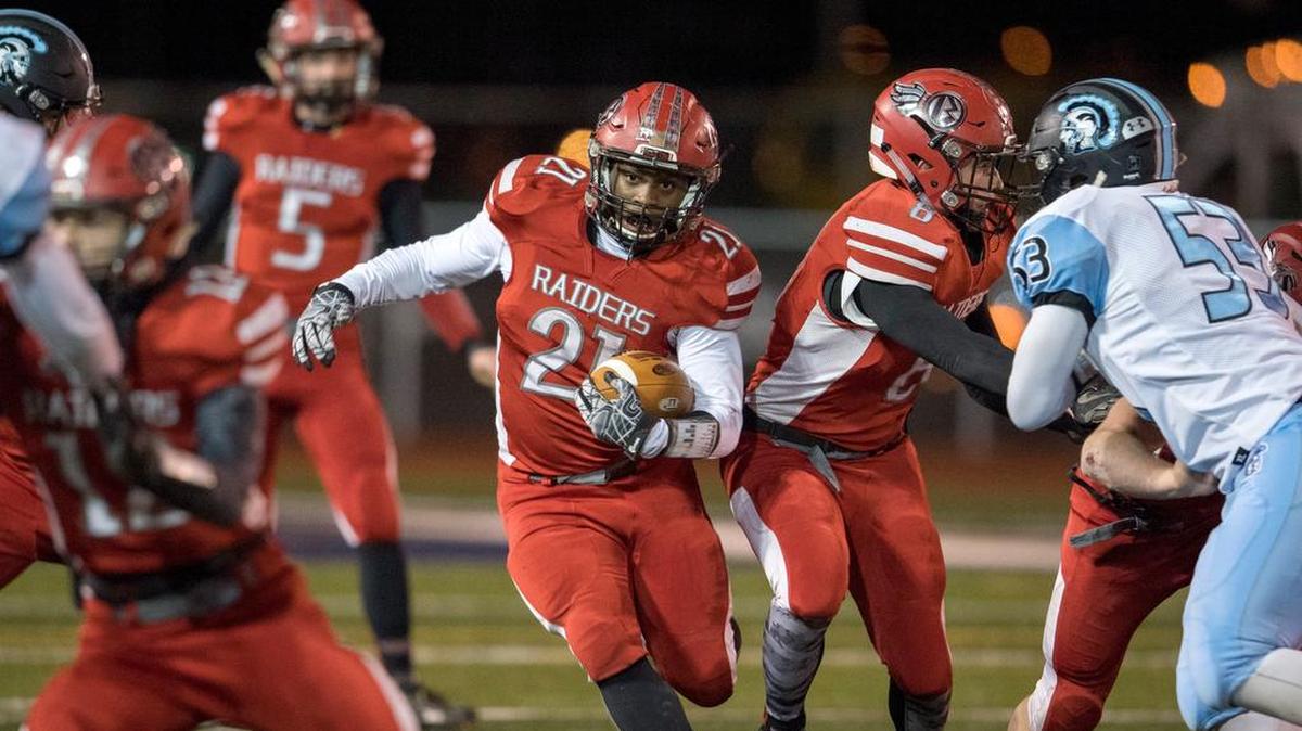 Bellefonte's Dexter Gallishaw follows his blockers during a run against Johnstown in the district championship last week. Despite Johnstown’s size advantage, the Red Raiders still rushed for 267 yards and four TDs in the 34-12 victory.