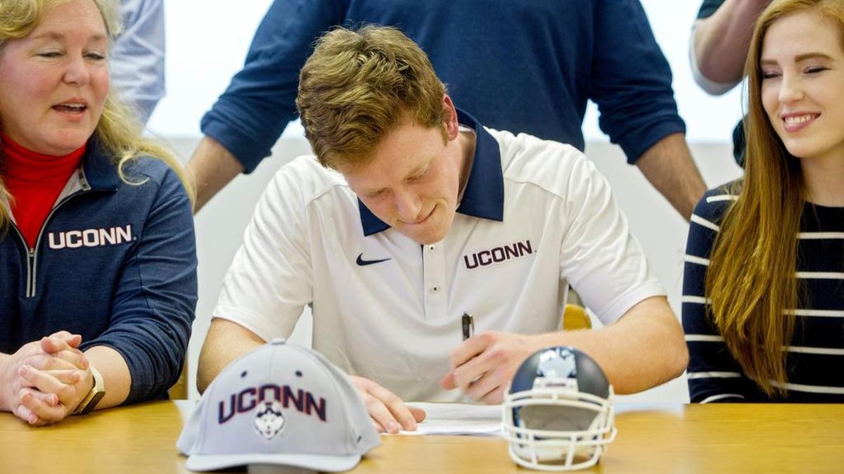 State College grad Brett Graham, seen here last February signing to play football at UConn, is averaging 39.2 yards per punt this season.