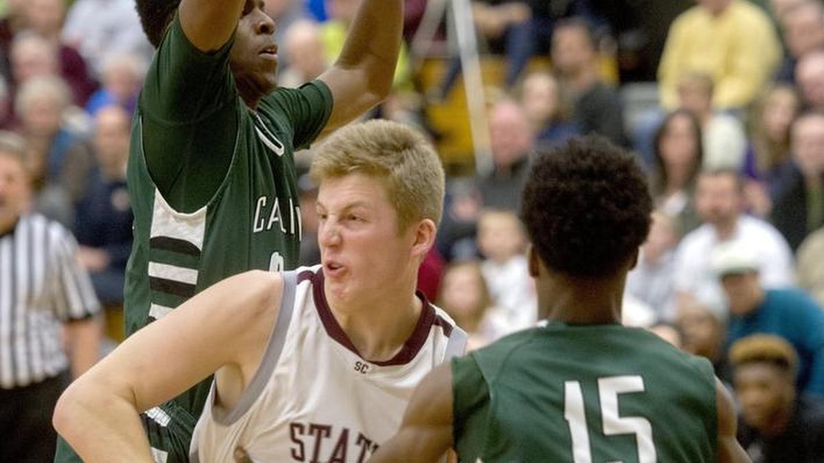 State College's Drew Friberg dribbles between Carlisle defenders during the Saturday, March 5, 2016 PIAA playoff game at Bald Eagle Area High School. Carlisle won, 64-54.