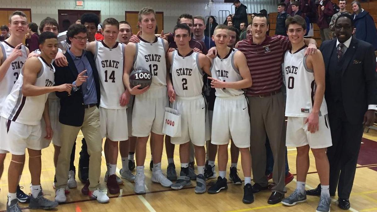 State College senior Drew Friberg (12) celebrates scoring his 1,000th career point with his teammates after the Little Lions defeated Central Dauphin 59-48 Friday night.