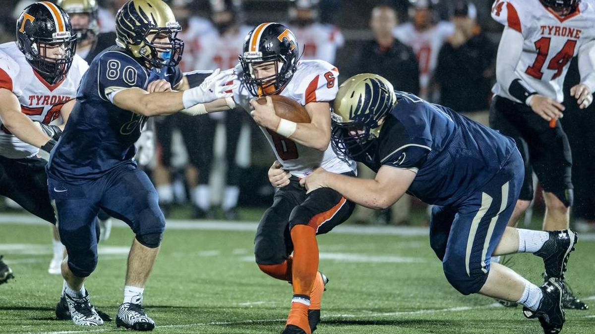 Bald Eagle Area's Rilee Bechdel and Hunter Weston stop Tyrone's Brandon Loose during the Sept. 30 game.