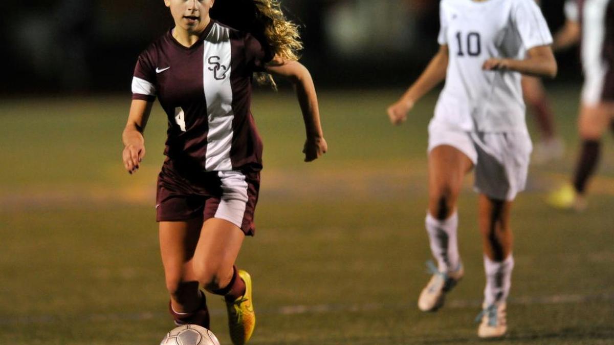 State College's Kelly Mejia pushes the ball downfield against Hollidaysburg's Abbey Nebelski during a District 6 championship soccer game on Wednesday, Oct. 29, 2014.