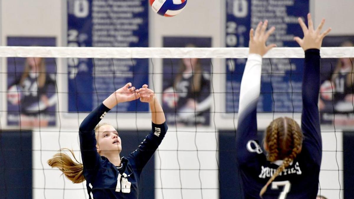 Bald Eagle Area's Grace Hugar hits the ball as Philipsburg-Osceola's Mollie Maguire jumps to block during a match last season.