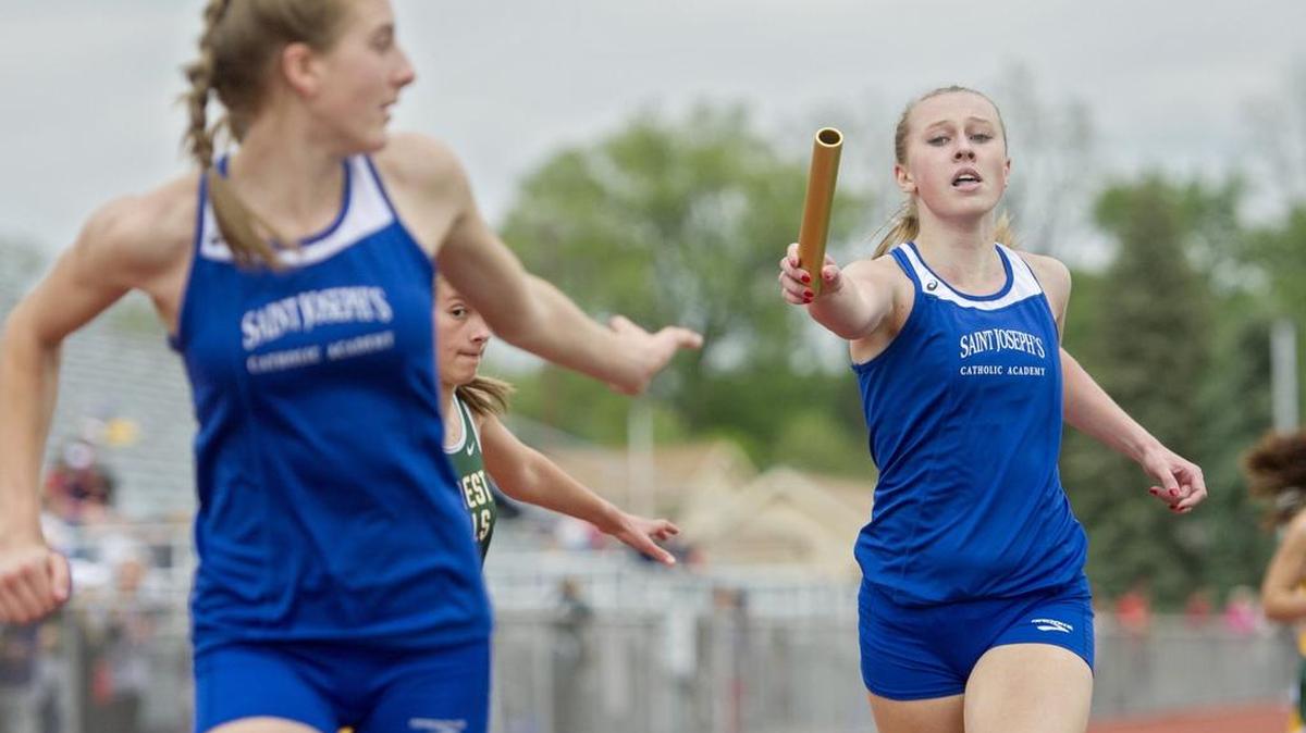 Kate Ott, of St. Joseph’s, hands off to Sera Mazza for the last leg of the 4x800 meter relay during the District 6 AA Track and Field Championships on Tuesday, May 17, 2016 at Mansion Park.