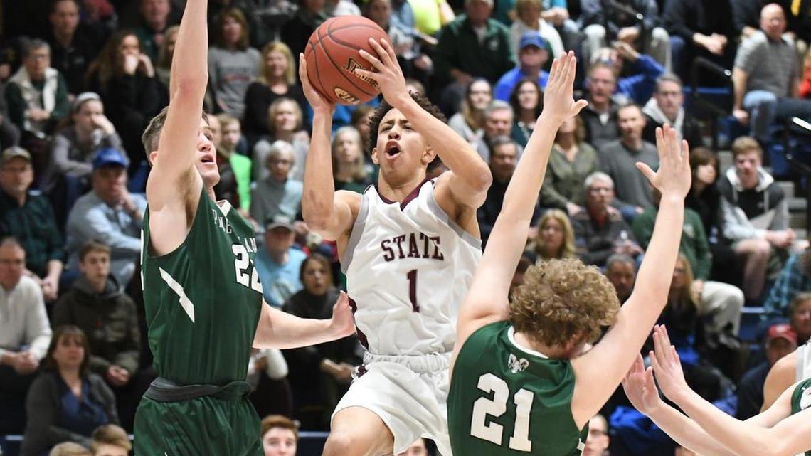 State College guard Keaton Ellis drives through the Pine-Richland defense Wednesday night. The Little Lions fell 83-63 to the Rams in the second round of the state playoffs.