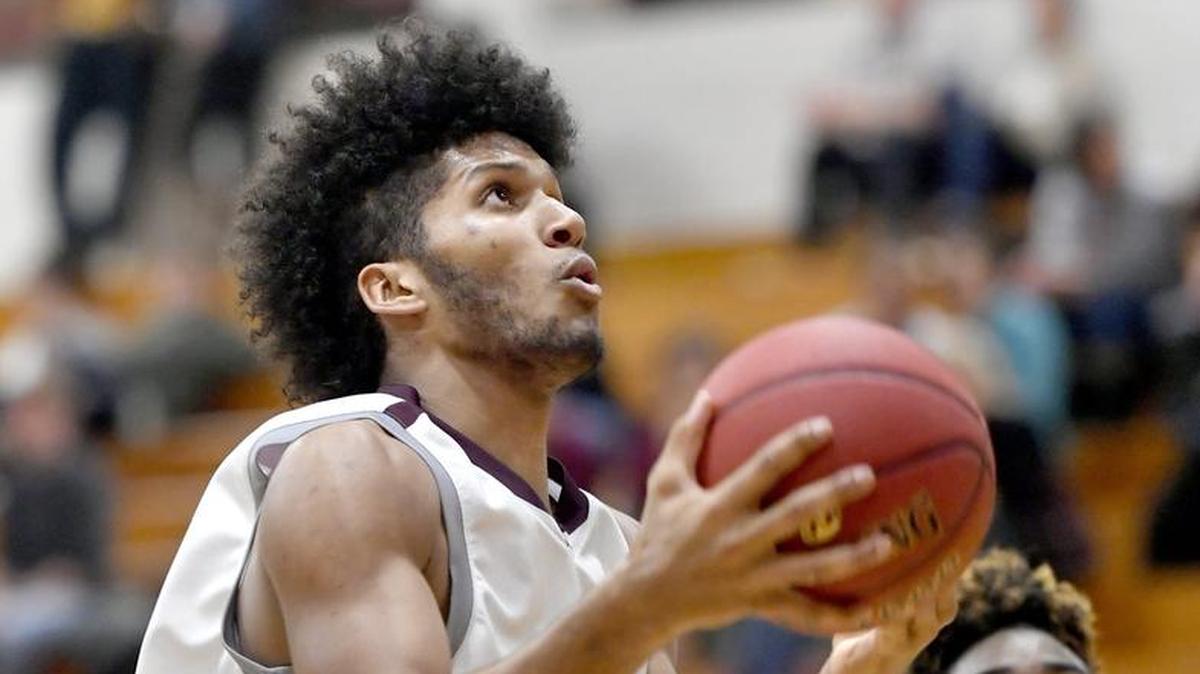 State College's Brandon Clark goes in for a basket ahead of Central Dauphin East defenders during the game Friday.