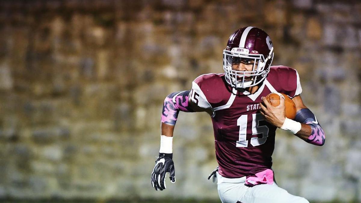 State High’s punter, Brandon Clark, is forced to run the ball out of his own end zone Friday at Memorial Field in State College by Harrisburg High School’s defense. (For the CDT/Steve Manuel)