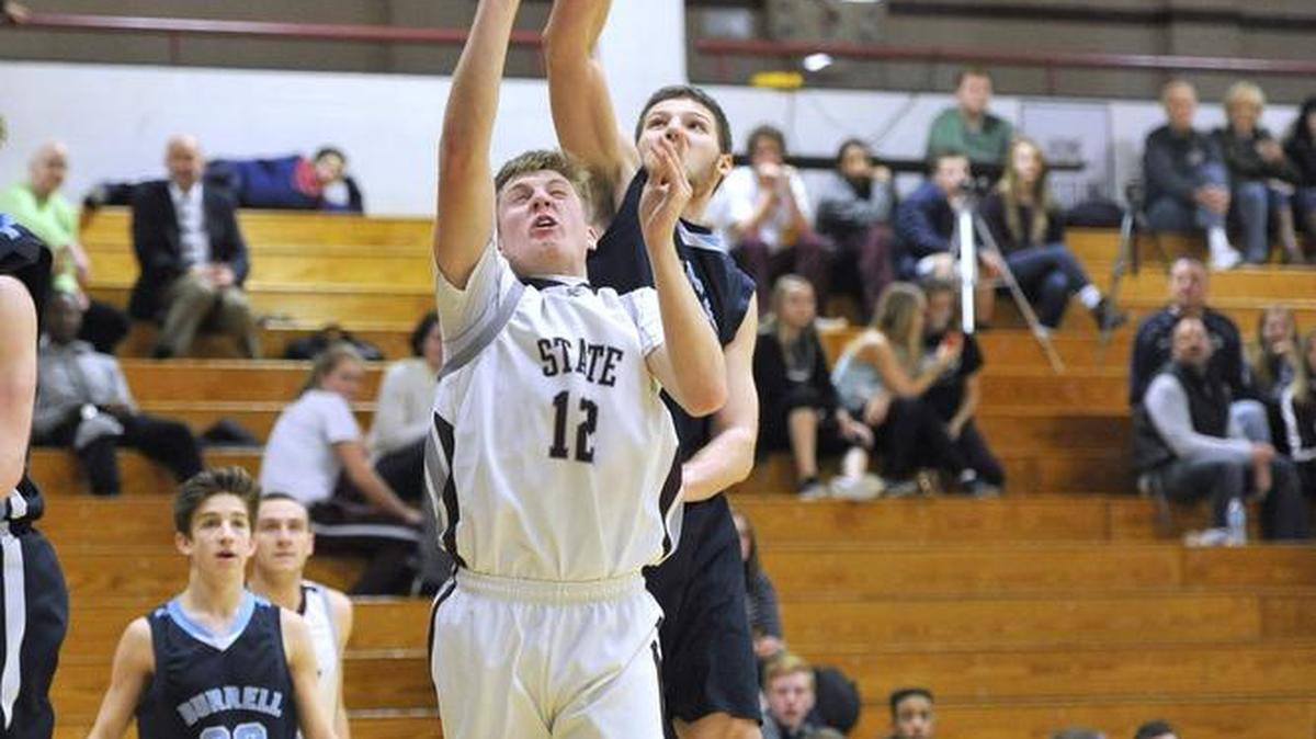 State College’s Drew Friberg (12) attempts a shot at the basket while a Burrell High School player attempts a block at the Kiwanis Holiday Basketball Classic on December 29, 2015.