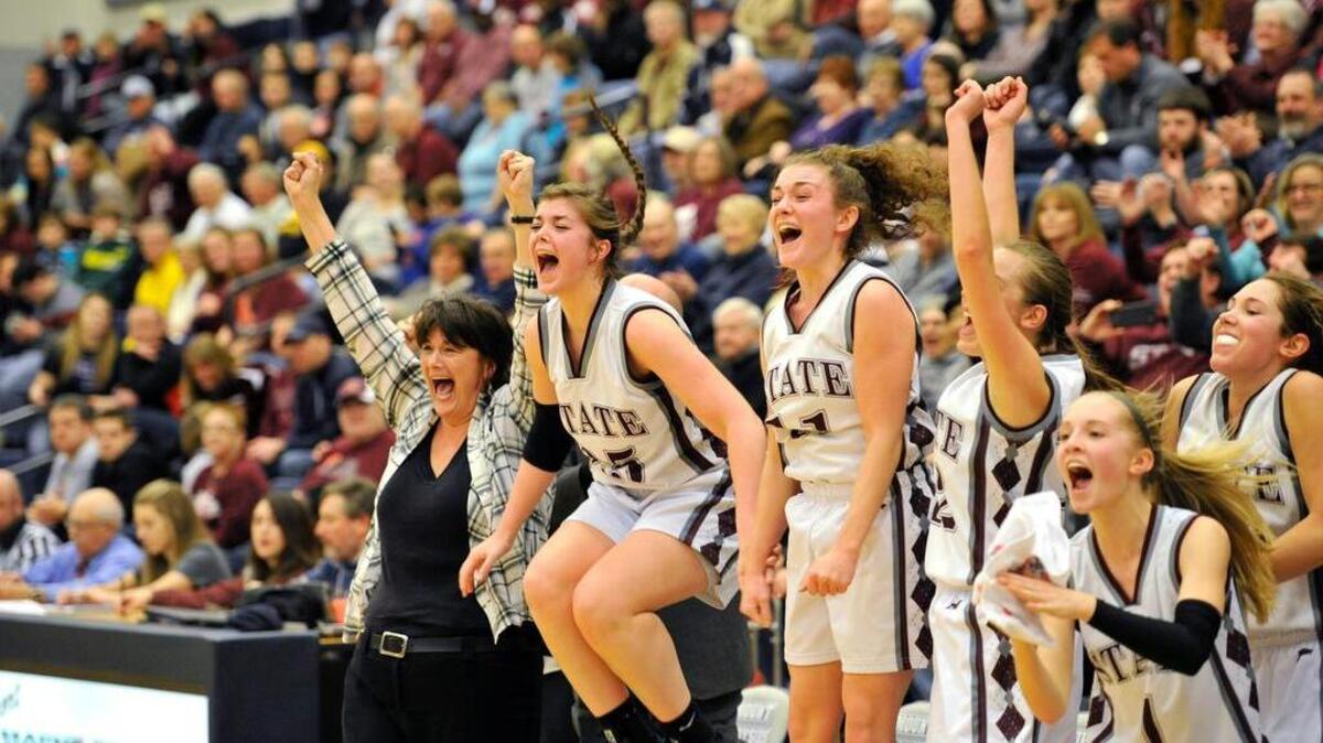 State College girls’ basketball coach Bethany Irwin and her team celebrate after winning the AAAA district title in February. After 23 years of coaching the team, Irwin is stepping down.