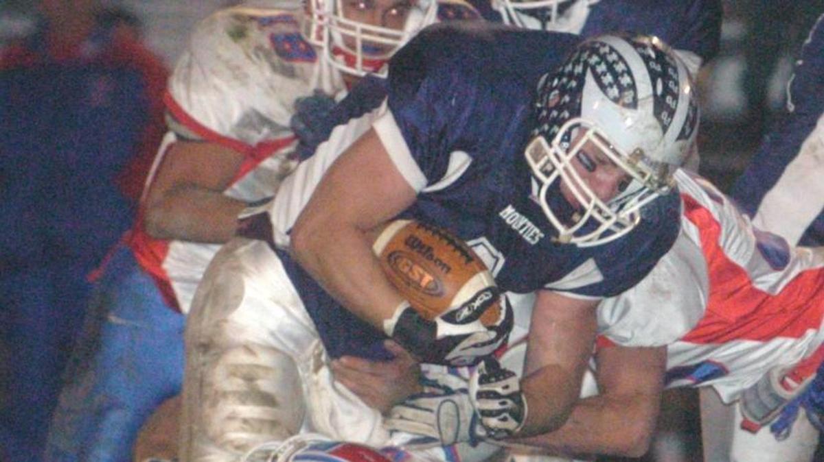 Philipsburg-Osceola’s Dimitri Sidorick is tackled by Richland's Marco Pecora (2), Jordan Curcija (18) and Chad Miller, right, in the first quarter of their District 5-6 Class 2A quarterfinal game on Nov. 10, 2007.
