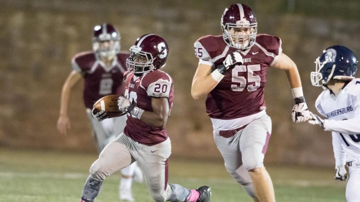 State College’s Collin Deboef (55) helps escort running back Tristen Lyons down the field against Chamersburg. The offensive line has helped the Little Lions rack up more than 2,700 rushing yards this season.
