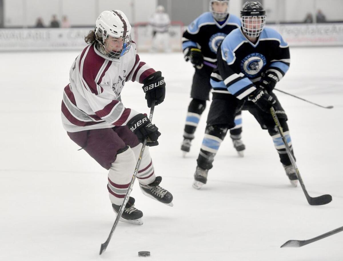 State College’s Kaleb Barth skates down the ice with the puck ahead of a Johnstown defender during the game on Nov. 30, 2017 at Pegula Ice Arena.