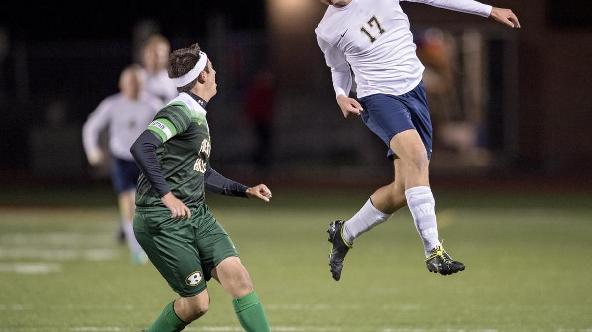 Bald Eagle Area’s Jacob Michael heads the ball over a Forest Hills defender during the Tuesday, October 25, 2016 District 6 Class AA quarterfinal at Bald Eagle Area’s Alumni Field.
