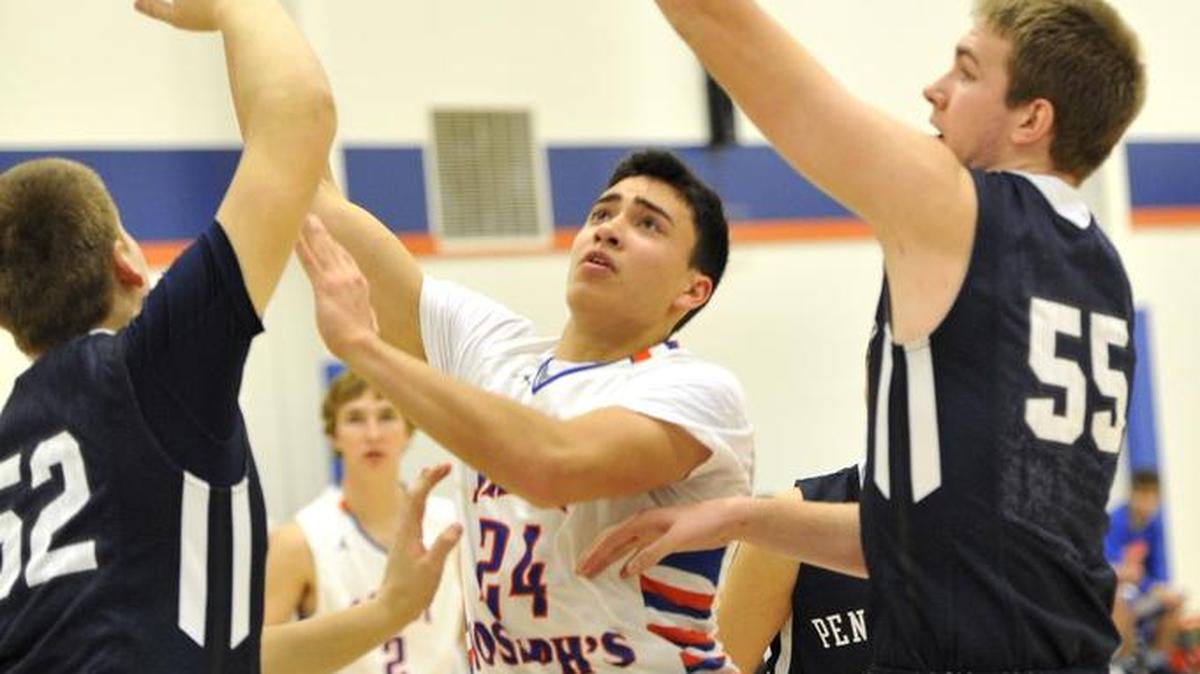 St. Joseph's Mariano Sanchez puts up a shot between Penns Valley's Luke Snyder, left, and Zach Engle during a boys basketball game on Wednesday, Dec. 16, 2015.