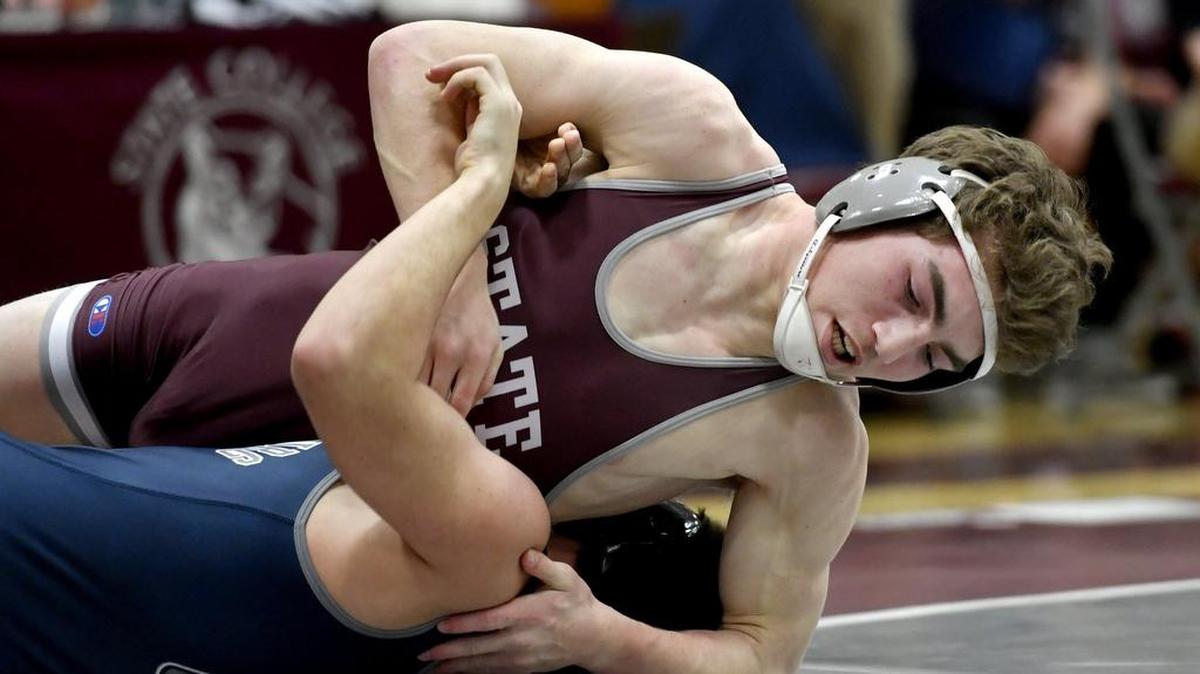 State College Ian Barr tries to control Chambersburg's Luke Nichter in the 170 pound bout during the Thursday match. Nicther won by major decision.