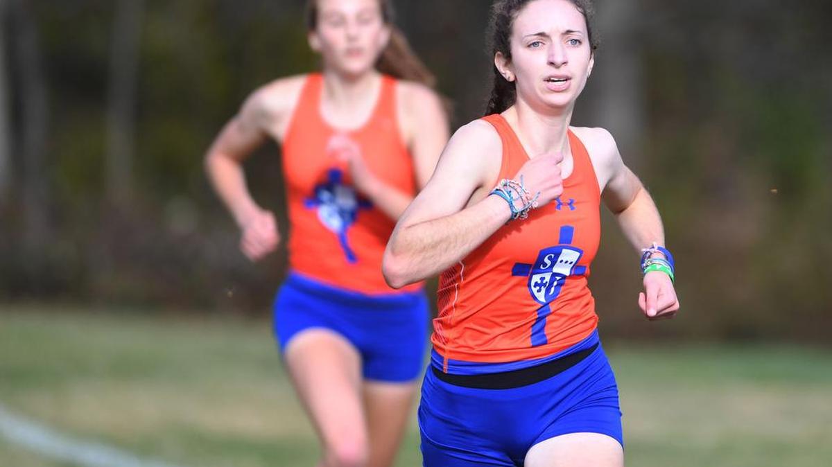 Julia Cusatis, right, of St. Joseph’s Catholic Academy, holds off teammate Sera Mazza to win the District 6 Class A championship on Oct. 28. Cusatis won despite suffering from juvenile arthritis.