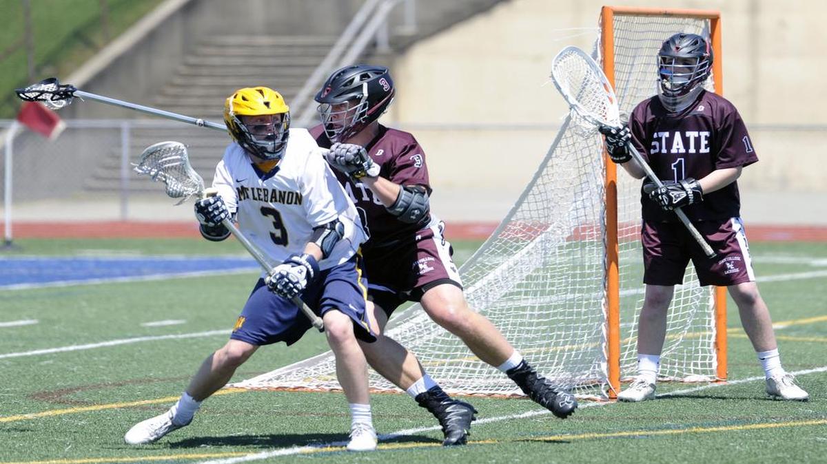 Mt. Lebanon’s Patrick Moeller, far left, looks for an open teammate Saturday while State College’s Peyton Edwards applies pressure and goalie Mike Hraba waits in the background. The Little Lions fell to Mt. Lebanon 11-4 in the PIAA Class 3A boys’ lacrosse quarterfinals at Hempfield Area’s Spartan Stadium.