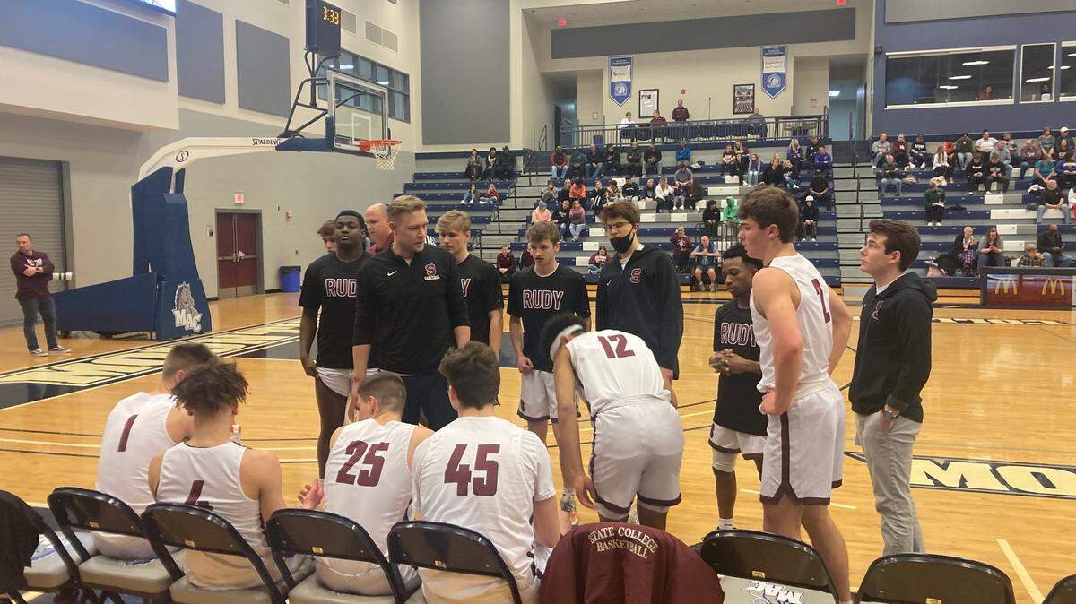 State College boys basketball huddles together during the District 6 championship game on Monday.