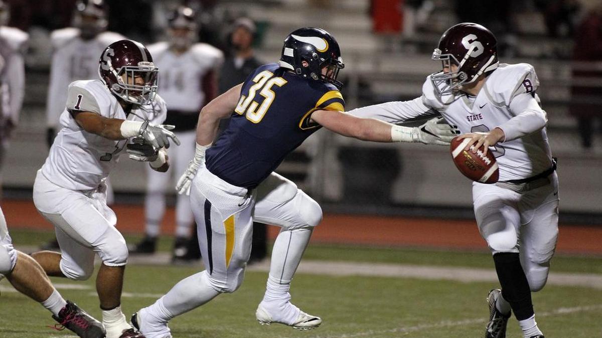 David Adams, of Central Catholic, sacks Drew Friberg, of State College, in 2015. Friberg is in the running to be State College’s starting quarterback this season.