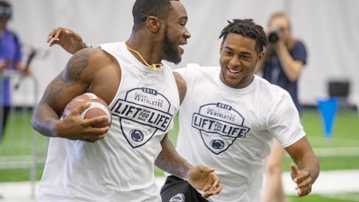 Penn State running back Miles Sanders jokes around with teammates before the annual Lift For Life at Holuba Hall in June 30.