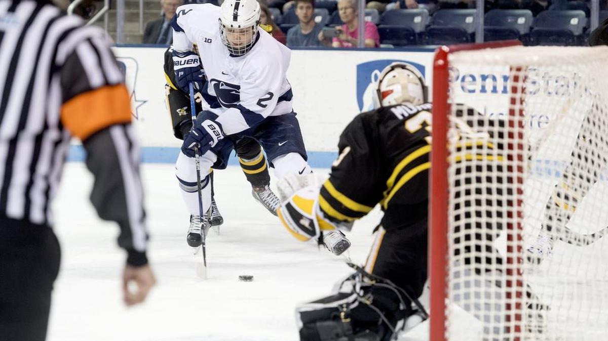 Penn State’s Cole Hults scores a goal around American International College’s Alex Murray during the Oct. 19 game at Pegula Ice Arena.