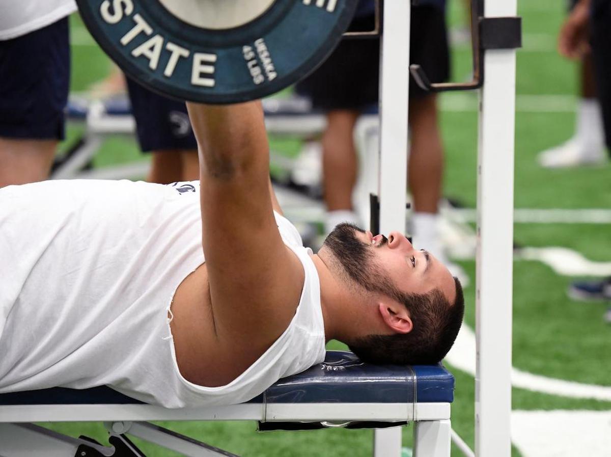 Penn State offensive lineman Steven Gonzalez participates in the bench press during Lift for Life Saturday, June 30, 2018 at Holuba Hall.