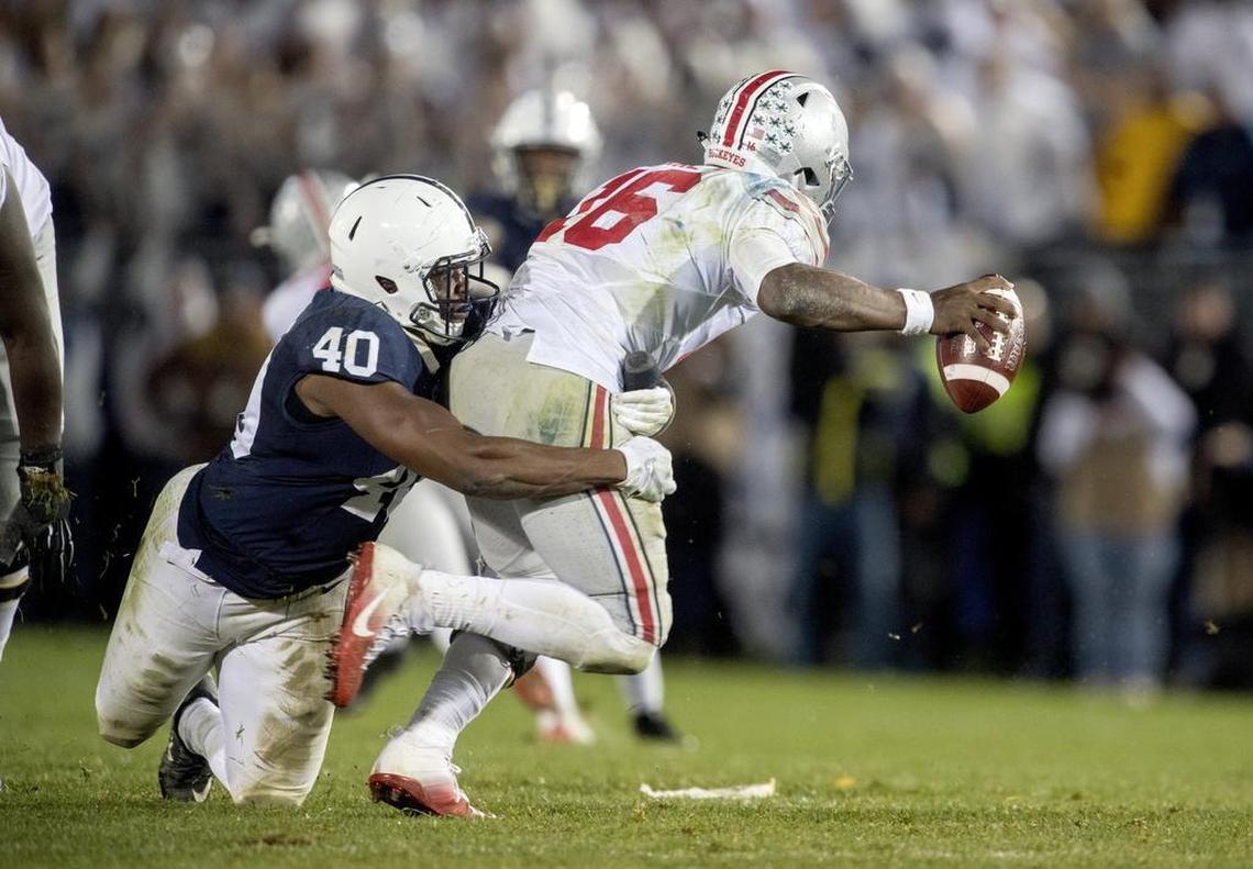 Penn State linebacker Jason Cabinda tackles Ohio State quarterback J.T. Barrett during the Saturday, October 22, 2016 game at Beaver Stadium. Penn State won, 24-21.
