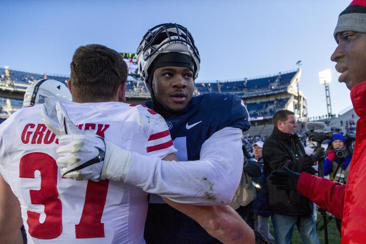 Linebacker Micah Parsons (11) hugs Wisconsin running back Garrett Groshek (37) after the game against Wisconsin at Beaver Stadium on Saturday, Nov. 10, 2018. No. 20 Penn State beat the Badgers 22-10.