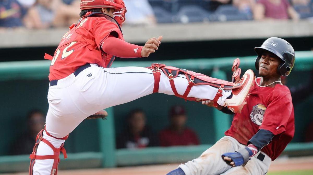 Mahoning Valley’s Gabriel Mejia is hit in the chest by Spikes’s catcher Chris Rivera as Mejia scores during Sunday’s game against Mahoning Valley at Medlar Field at Lubrano Park. Mahoning Valley defeated the Spikes 4-0.