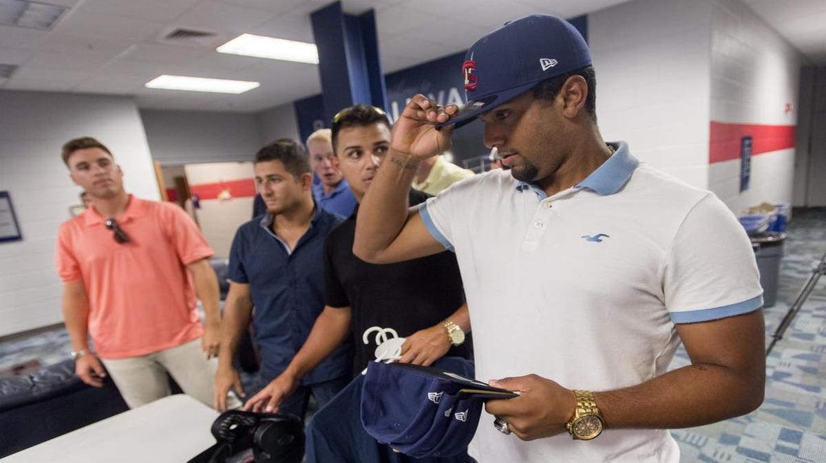 State College Spikes Ricardo Bautista tries on hats after arriving arriving at Medlar Field with his new teammates for the season on Tuesday.