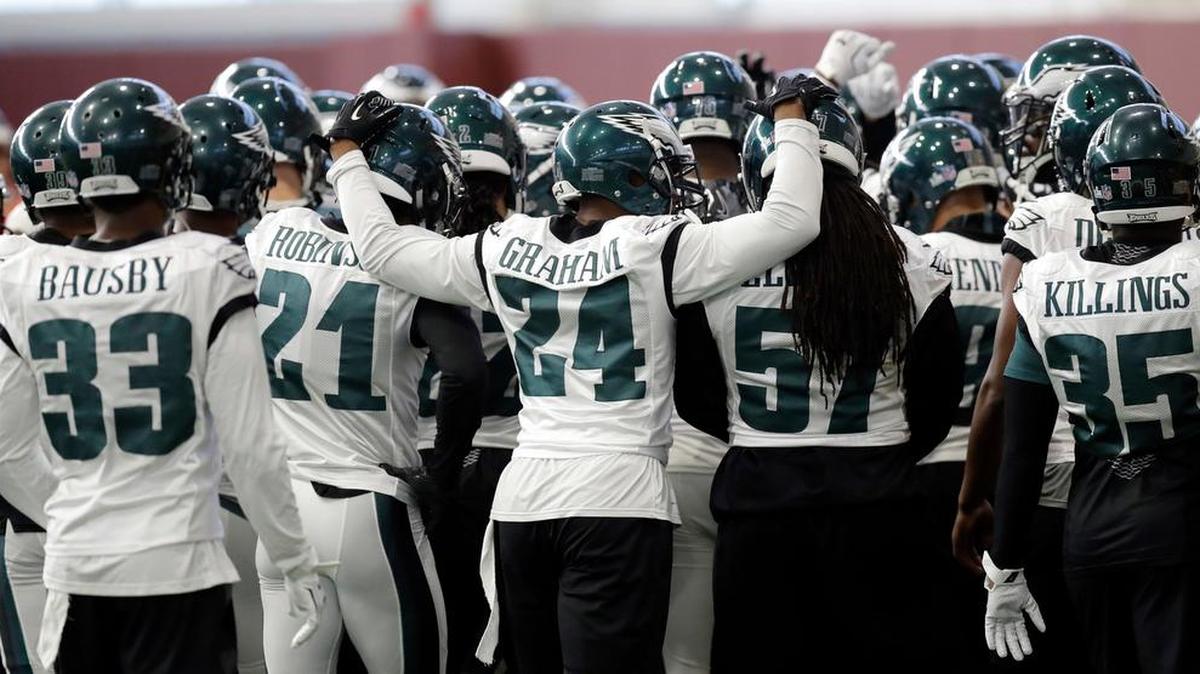 Philadelphia Eagles defensive back Corey Graham (24) reaches around teammates as the team huddles during a practice for the NFL Super Bowl 52 football game Wednesday, Jan. 31, 2018, in Minneapolis. Philadelphia is scheduled to face the New England Patriots Sunday. (AP Photo/Eric Gay)