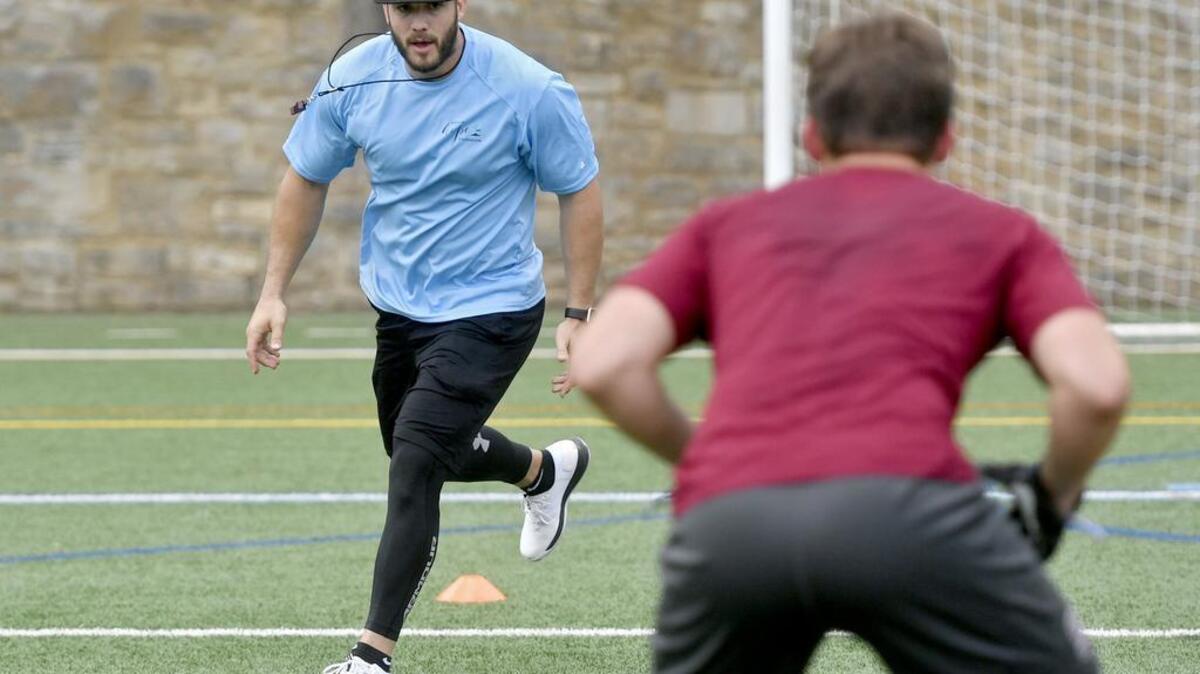 Nate Stupar goes over a drill with high school linebackers at the State of Hope Foundation Training Camp 2017 at Memorial Field on Saturday, June 24, 2017. Stupar is a linebacker for the New Orleans Saints and is a State High and Penn State alum.