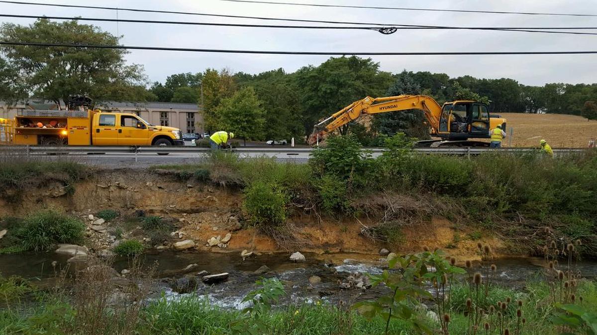 Crews work on updating Thompson Run to tend to erosion along the creek banks.