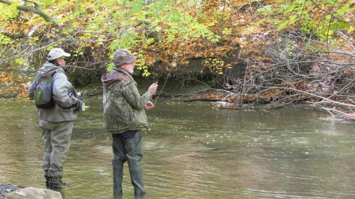 Chautauqua County guide Alberto Rey advises writer Tom Tatum about the best spot to place his fly.